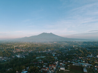 Morning view of Mount Gede with light mist and bright clouds, capturing serene and clear beauty