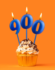 Blue candle number 900 - Birthday cupcake on orange background