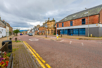 Obraz premium The historic High Street, the main street of shopping, cafes and businesses through the port city of Invergordon, Scotland.