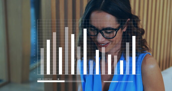 Image of graph, loading bars over smiling biracial woman typing on keyboard of laptop