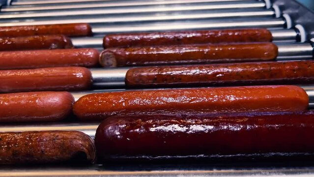 Sizzling Sausage Symphony: Fuel Station Gourmet | Rotating Grill Showcases Bratwurst and Frankfurters | Highway Culinary Haven | Speedy Comfort Bites on the Go