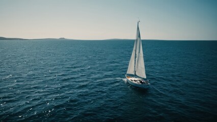 Fototapeta premium sailboat in the middle of a body of water with a boat in the background