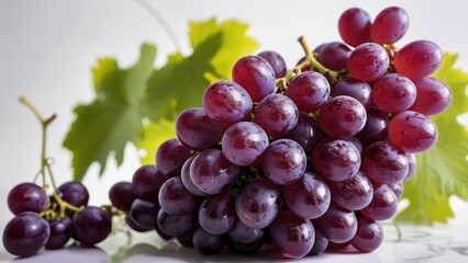 Fototapeta premium A vibrant purple grape bunch on a white background.
