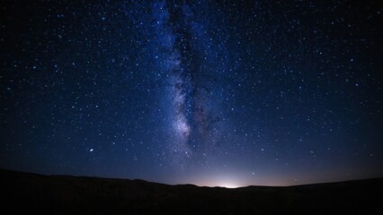 a photograph of the night sky is filled with stars and the milky shines brightly in the distance