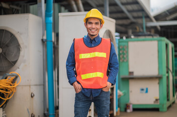 Asian engineer diligently inspects machinery in an industrial factory.Asian workers diligently...
