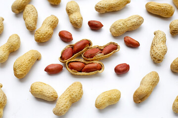 Roasted peanuts in shell on white background.