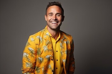 Obraz premium Portrait of a handsome young man in a yellow shirt. Studio shot.