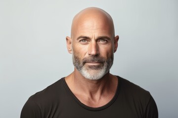 Portrait of mature man with grey hair and beard looking at camera