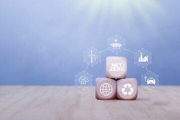 Net zero, carbon neutrality concept. Net zero icon at wood box on green blur background. Green...