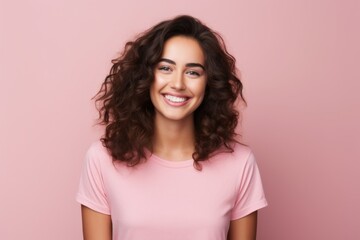 Fototapeta premium Portrait of beautiful young happy smiling woman, over pink background.