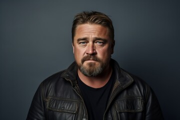 Fototapeta premium Portrait of a stylish man with a beard in a leather jacket.