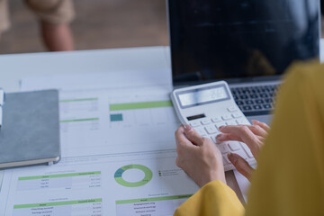 A professional photograph depicting two female entrepreneurs engaged in a collaborative discussion while diligently working in their corporate office environment.