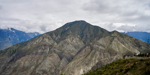 a huge rock mountain under heavy cloud