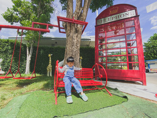 Children playing happily on a colorful playground in a sunny park filled with slides, swings, and other fun equipment under a bright blue sky