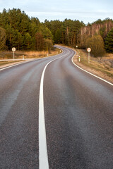 S-curve Country Road In A Forest. Front View Of An Empty Curvy Roadway And Fall Foliage