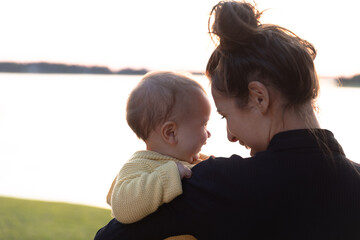 Mother and young daughter smiling and laughing- close up on faces 
