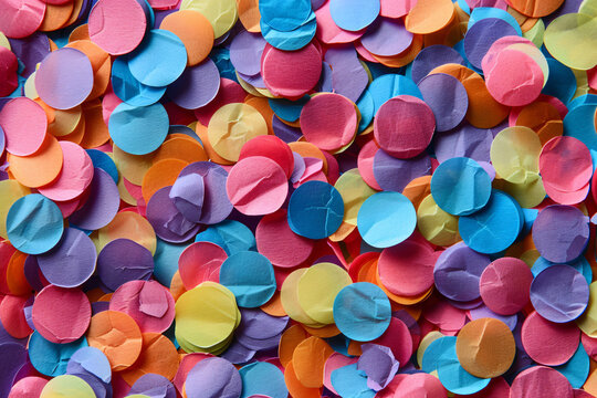 Colorful round confetti background. Background with colorful paper circles in the style of festive celebration or party decoration, top view.


