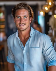 Obraz premium A man in a blue shirt smiling at the camera.