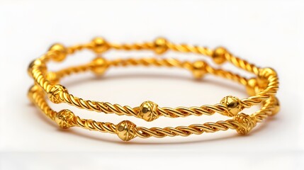 Fototapeta premium Exquisite Gold Bracelets Showcased Against Pristine White Background