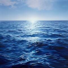 Obraz premium A blue ocean with sun rays shining through the water surface, showcasing an underwater view