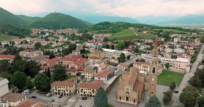 Cornuda, Italy Aerial Cityscape: Cathedral Architecture and Bell Tower in Urban Setting. High quality 4k footage