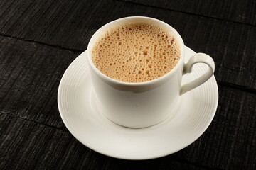 Indian milk tea served in cup.