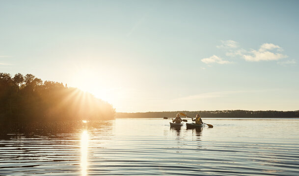 Couple, kayak and ocean with paddle in sunset for travel, hobby or outdoor holiday in water, lake or nature. Man and woman rowing boat in sunshine for canoeing, adventure or journey at sea on mockup