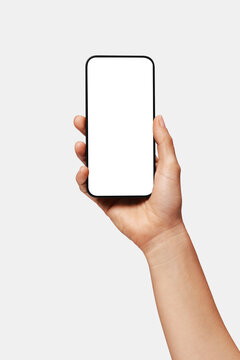 Close-up of woman hand holding modern smartphone iphone mockup. New modern black frameless smartphone mockup with blank white screen. Isolated on white background high-quality studio shot, Modern smar