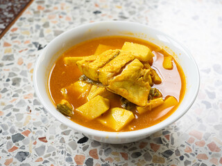 Thai Southern yellow curry with sea bass and coconut shoots