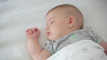 Close up of adorable newborn baby boy sleeping carelessly