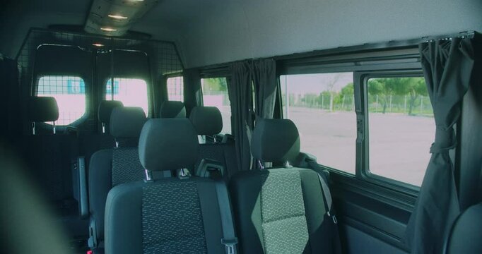 Amazing slow motion shot of the seats inside a very large, elegant and modern black van for transporting musical bands in Madrid.