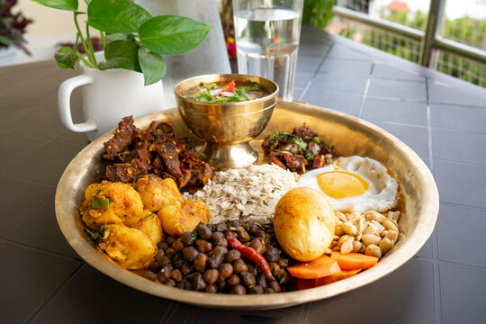Newari Khaja Set Typical Nepali Thali with Rice Flakes, Choyila, Eggs, Chickpeas, Aalu Sadheko Lunch