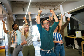 Fototapeta premium Happy business people celebrating success at company