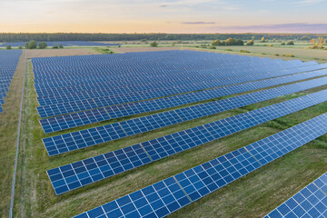 Solar panels in a field in summer day in Estonia, drone view aerial photo.