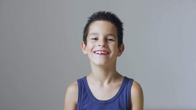 Funny little preschool child boy smiling and looking at camera.
