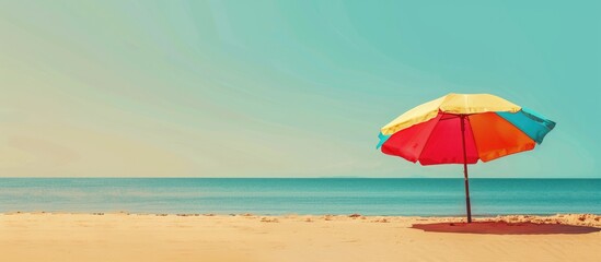 Beach umbrella on sandy shore with clear sky, blank area