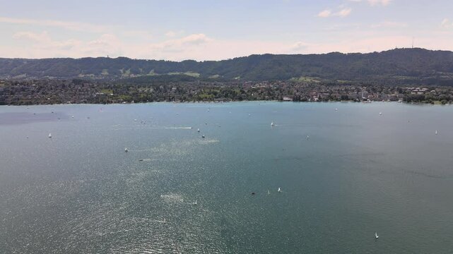Drone flyover shot over Lake Z&uuml;rich in Switzerland towards Kilchberg