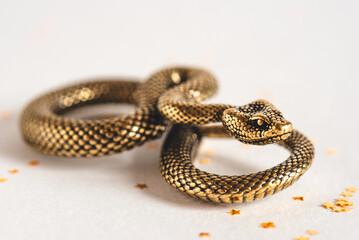 Bronze snake figurine on a white background. The symbol of 2025. Happy Chinese New Year.