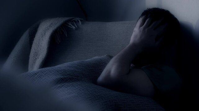 Man unable to sleep at night in bed. Concept of insomnia