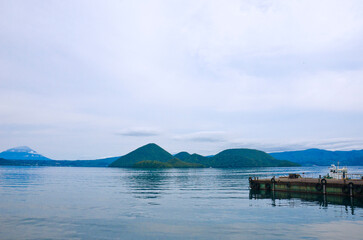 Scenery of Lake Toya and Nakajima island with Mt. Yotei in background in Toyako onsen in Hokkaido, Japan.