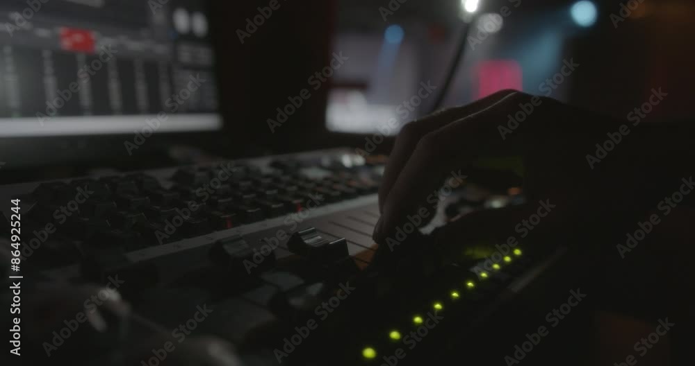 Poster amazing slow motion shot of the detail of a hand of a live show sound engineer moving a fade of the 