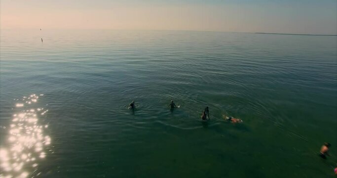 People playing in shallow water at sunset which feels like heaven. First Encounter Beach, Cape Cod, Massachusetts, United States of America.