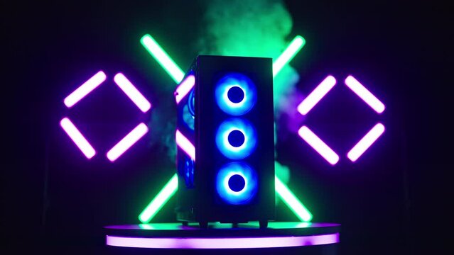 Smoking hot RGB gaming computer on turning platform with neon tubes studio shot
