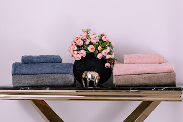 Spa, bathroom background. Stack of clean and folded towels. Bathroom and resort concept and interior accessories with copy space. Neutral beige colors.