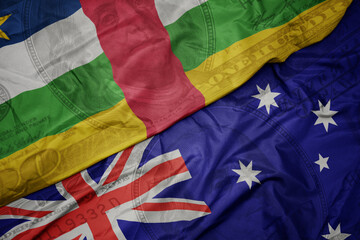 waving colorful flag of central african republic and national flag of australia on the dollar money background. finance concept.