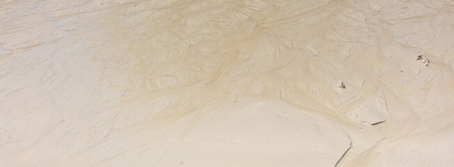 White sand on the seashore as an abstract background. Texture