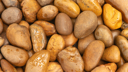 Round stones in the wall as an abstract background. Texture