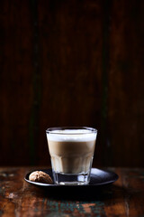Coffee with milk on rustic wooden background. Soft focus. Close up. Copy space.	