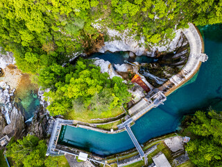 Waterfall and dam in the Julian Prealps. Crosis, pearl of Tarcento. Nature and engineering.
