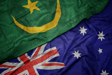 waving colorful flag of mauritania and national flag of australia on the dollar money background. finance concept.